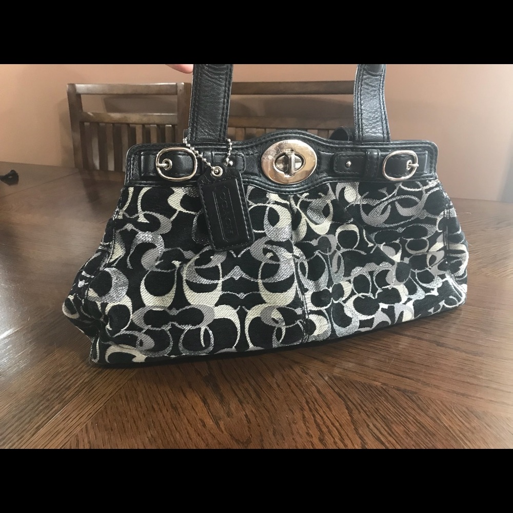 Black & silver colored coach purse.